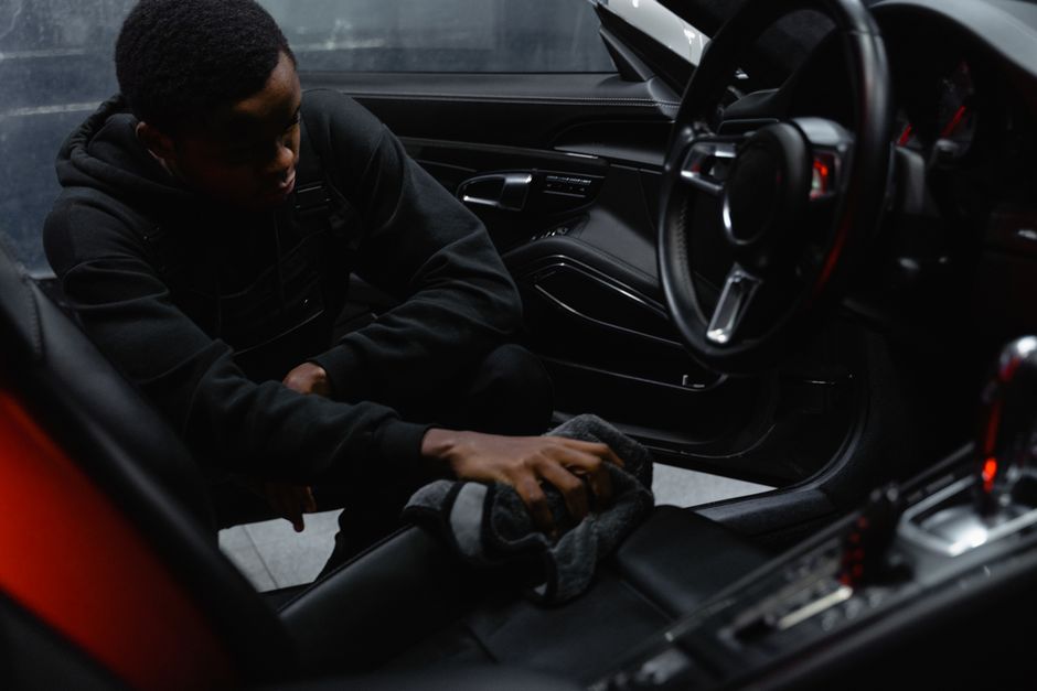 Wiping down a luxury car dashboard